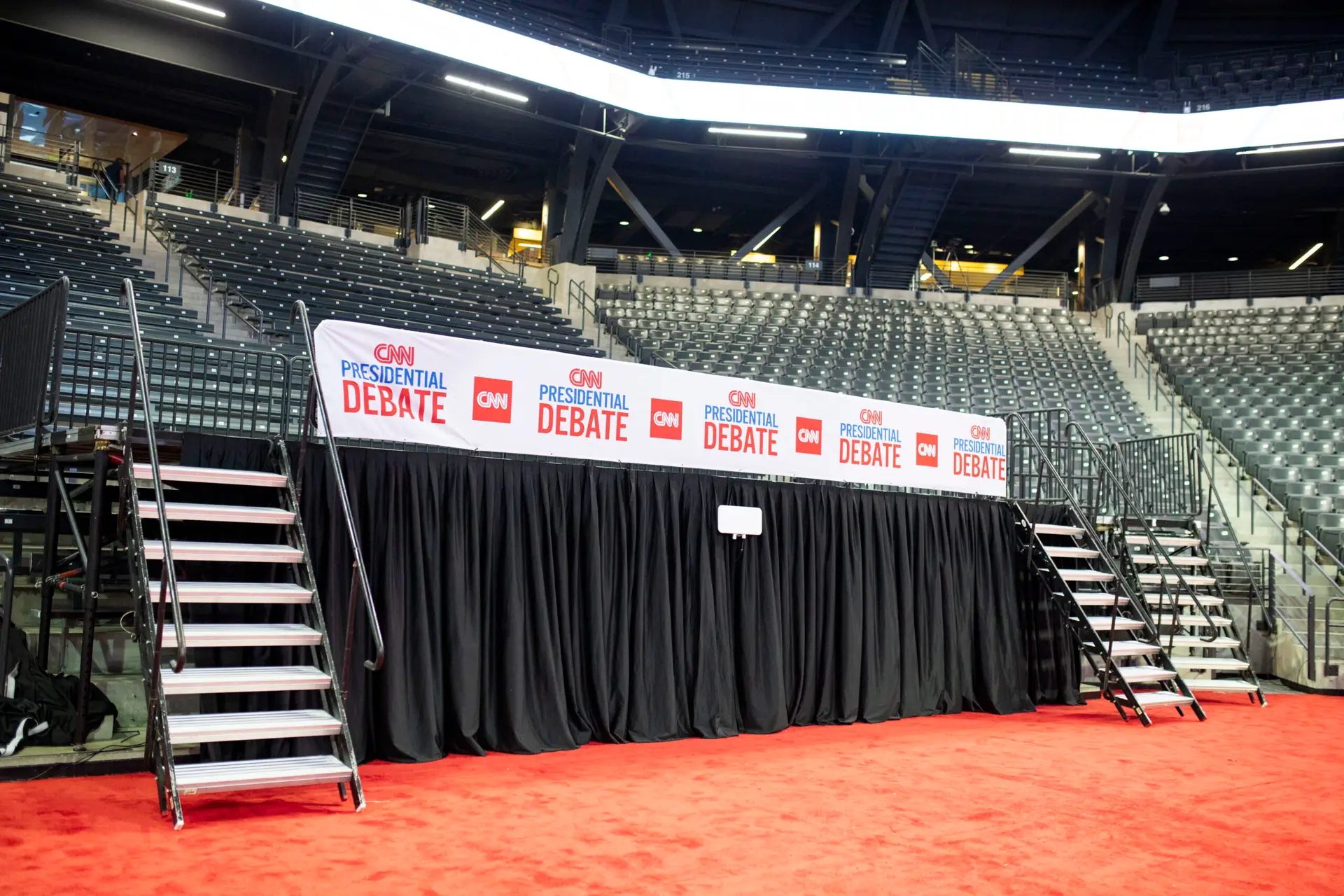 CNN Presidential Debate press stage setup with stairs, red carpet, and branded backdrop inside an arena